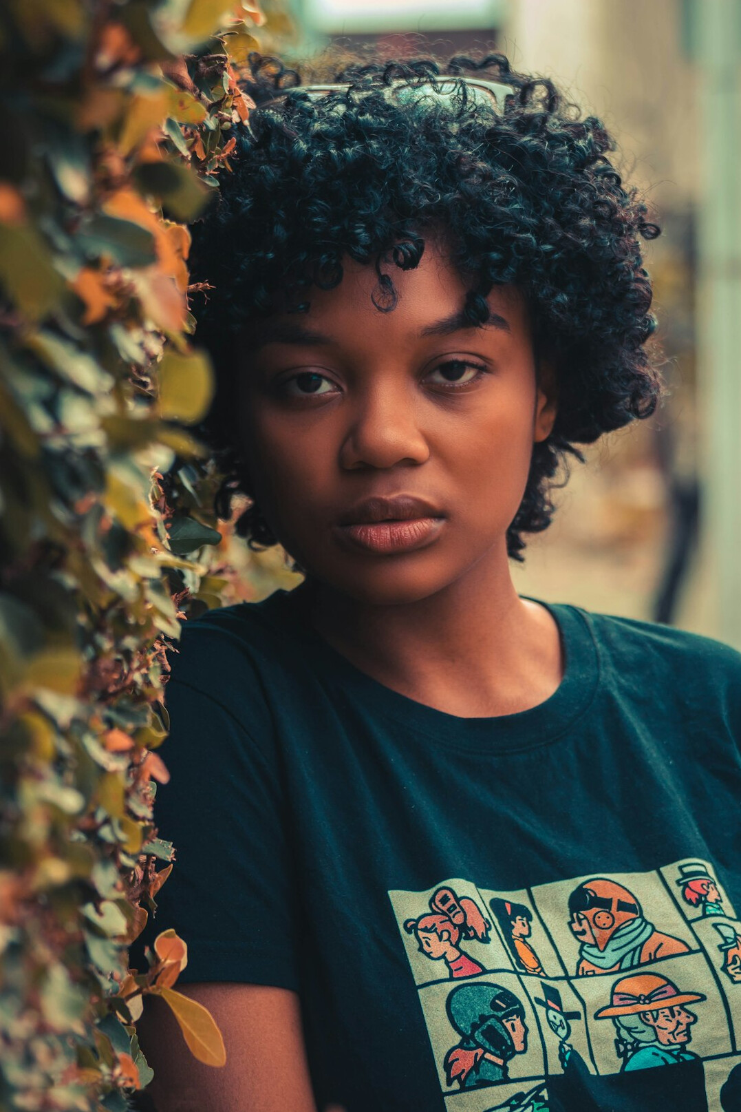 Portrait of a young Black woman with short curly hair smiling