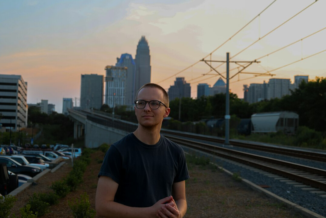 Portrait of an Eastern European man in his thirties wearing glasses
